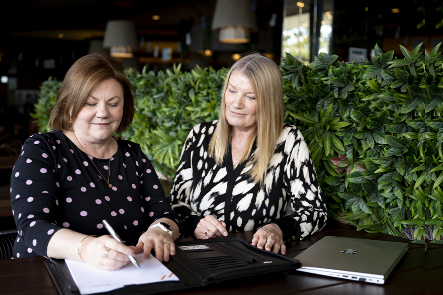 Small business accountant Brisbane reviewing financial information with a client